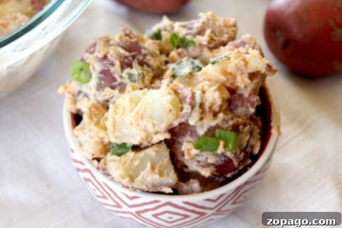 Light & Fresh Potato Salad 3 A bowl of simple potato salad, garnished minimally, emphasizing its fresh and light appeal without mayo.