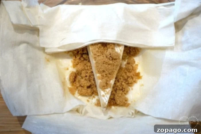 Flaky Baked Brie 4 Easy baked brie recipe in a pie dish, wrapped in phyllo dough and ready for the oven.