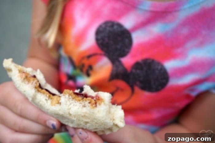 Helpful Disneyland tips for families: where to eat, what to pack, and discount tickets. Family enjoying snacks inside Disneyland
