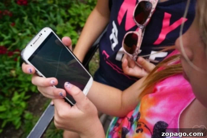 Leverage these Disneyland tips to manage wait times, making every moment of your family vacation enjoyable. Kids playing a game while waiting, smart Disneyland tip for long lines.