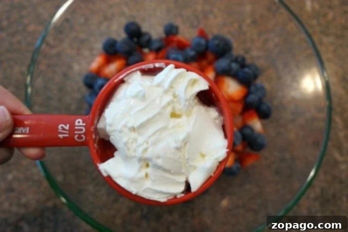 Easy fruit salad recipe that's super creamy and easy to make.. The perfect BBQ side dish or a light fruit dessert idea that everyone will love! Easy fruit salad recipe