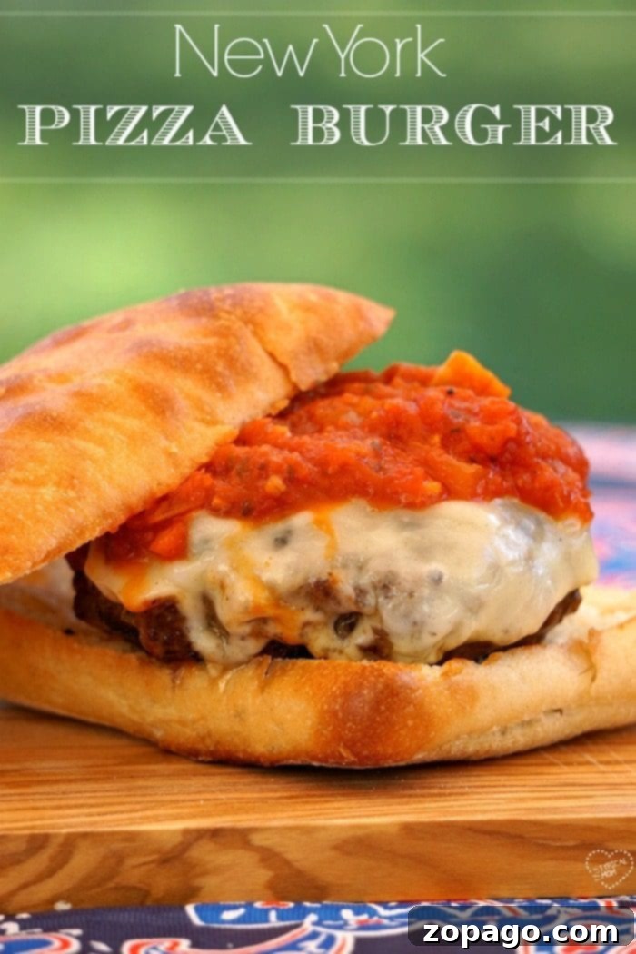 This New York pizza burger is the bomb!! Easy recipe that is to die for, the best burger ever! A New York pizza burger with melted cheese and tomato sauce on a bun, topped with a knife, sits enticingly on a wooden board, ready to be enjoyed.