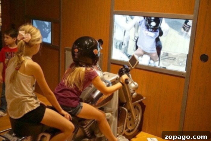Interactive Harley Davidson exhibit at Discovery Cube OC showing a customizable motorcycle display with various parts