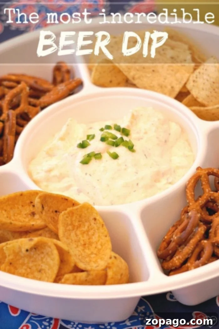The ultimate easy beer cheese dip recipe, perfect for pretzels, chips, or beer bread. A party favorite! A vibrant cold beer cheese dip served with an assortment of pretzels, tortilla chips, and fresh vegetables on a rustic wooden board.