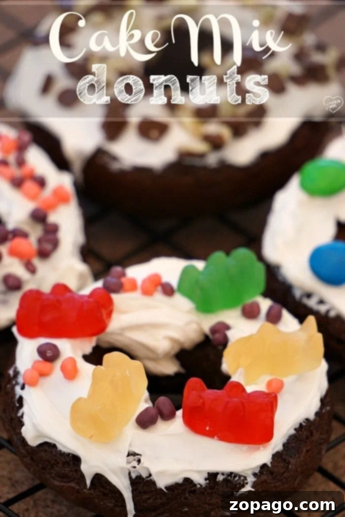 Cake mix donuts are so easy to make using any flavor of boxed cake mix you want! It's an easy baking project with your kids. #cakemix #donuts #doughnuts #dessert #bakingwithkids #dessert #breakfast A close-up of a beautifully glazed chocolate cake mix donut adorned with vibrant sprinkles, ready to be enjoyed.