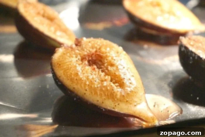 Sweet Baked Figs 6 Close-up of roasted pear halves with a sprinkle of brown sugar on a baking sheet, reminiscent of how to bake figs in the oven.