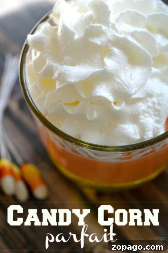Halloween Candy Corn Jello Delight 4 Three delightful candy corn parfaits in elegant glasses, showcasing their iconic Halloween colors and creamy textures, a must-have Fall dessert.