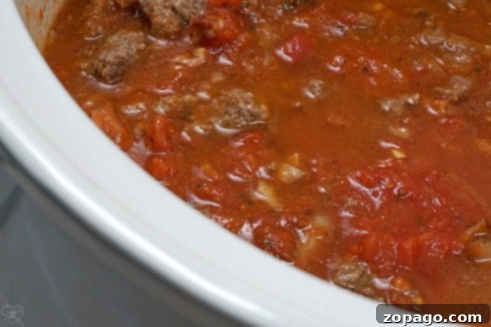 A hearty classic hamburger helper recipe cooks in a slow cooker for dinner.