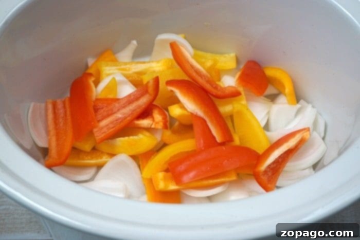 Easy crockpot chicken fajitas recipe your whole family will love!! Our favorite slow cooker recipe that's cheap, really easy and a healthy meal too. #crockpot #chickenfajitas #fajitas #slowcooker #crockpotrecipes A beautifully presented spread of slow cooker chicken fajitas, served with fresh tortillas, vibrant lime wedges, and chopped cilantro on the side.