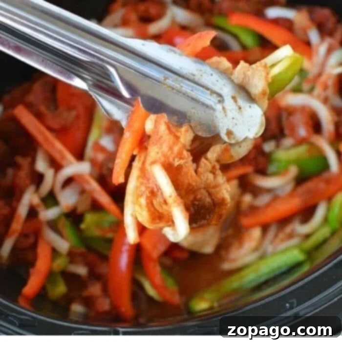 One Pot Wonder Chicken Fajitas 4 Close-up of perfectly shredded crockpot chicken fajitas with colorful bell peppers and onions, ready to be integrated into tortillas or bowls.