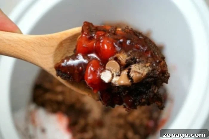 Slow Cooker Chocolate Lava Cake 7 Close-up of Crockpot Lava Cake in a slow cooker, highlighting the rich chocolate and cherry filling.