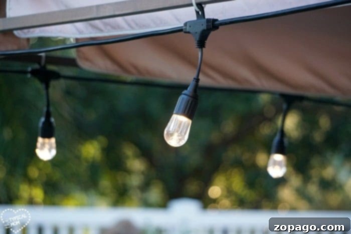Unlock Your Kids' World 6 Enbrighten Cafe Lights creating a warm and inviting atmosphere in an outdoor setting.