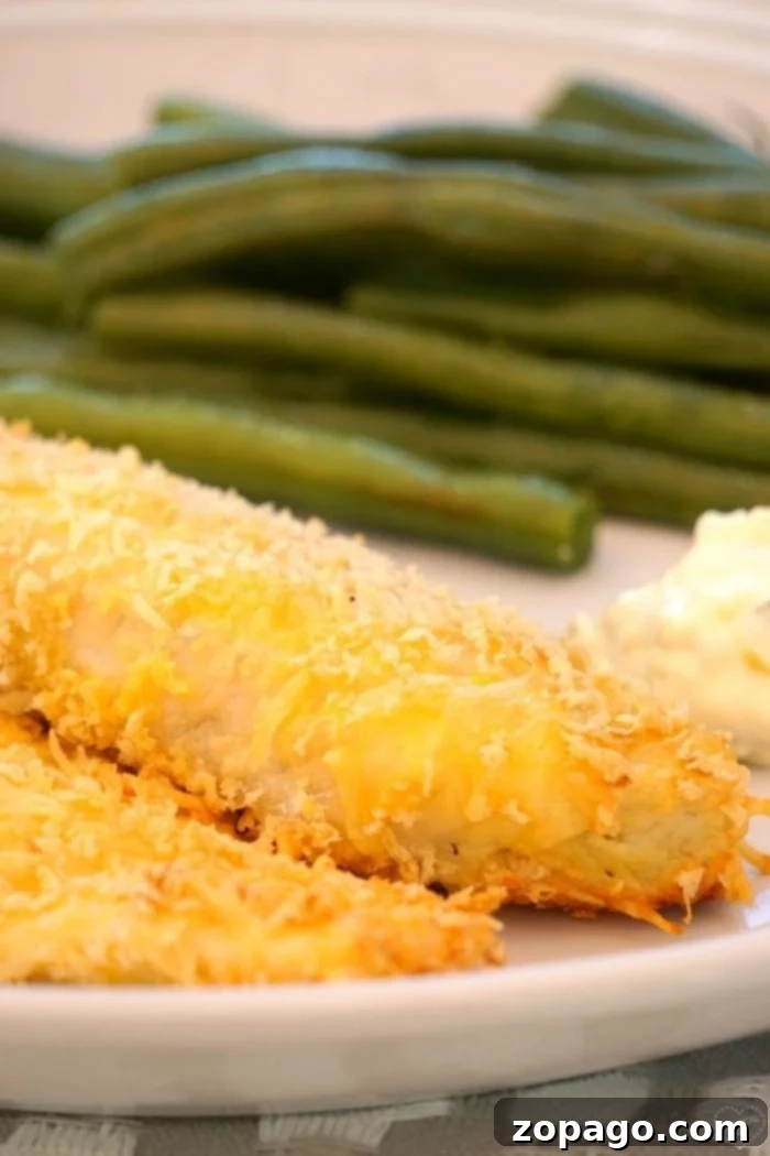Crispy Oven-Fried Fish: Healthy, Easy, and Delicious for the Whole Family Crispy oven fried fish fillets served on a plate, a healthy alternative to traditional fried fish.