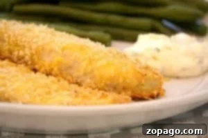 Crispy Oven-Baked Fish 8 Plated oven-fried fish fillets with green beans and tartar sauce, ready to eat