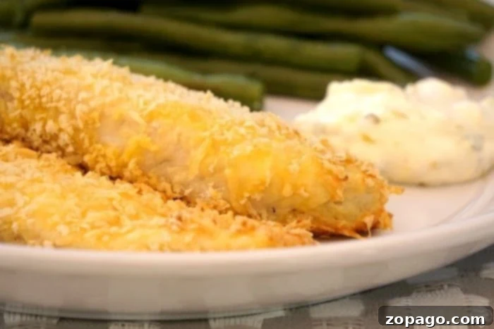 Crispy Oven-Baked Fish 2 Close-up of breaded fish fillets neatly arranged on a baking sheet, ready for the oven