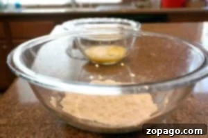 Crispy Oven-Baked Fish 5 Two glass bowls, one with flour and one with whisked eggs, prepared for breading fish