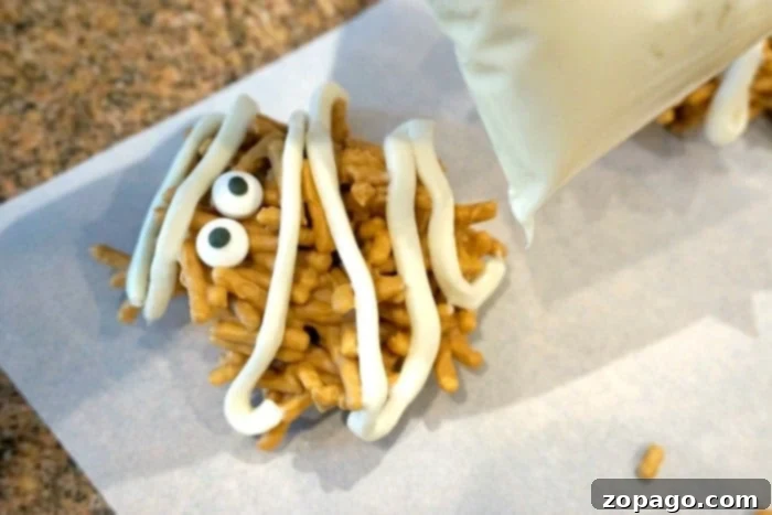 Spooky Halloween Haystacks 5 Halloween haystacks being scooped onto parchment paper for shaping