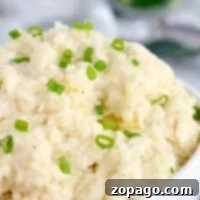 Set-It-And-Forget-It Mashed Potatoes 3 A bowl of slow cooker mashed potatoes topped with chopped green onions.