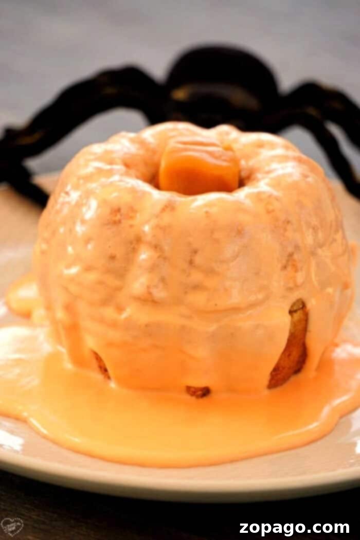 Easy Pumpkin Bundtlets 2 mini pumpkin bundt cake, topped with orange icing and a caramel stem