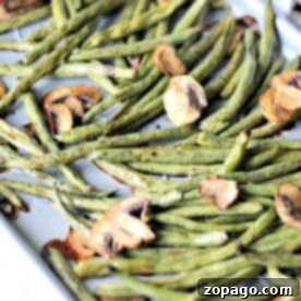 Sheet pan green beans and mushrooms roast to perfection, creating a delightful medley of textures and flavors.