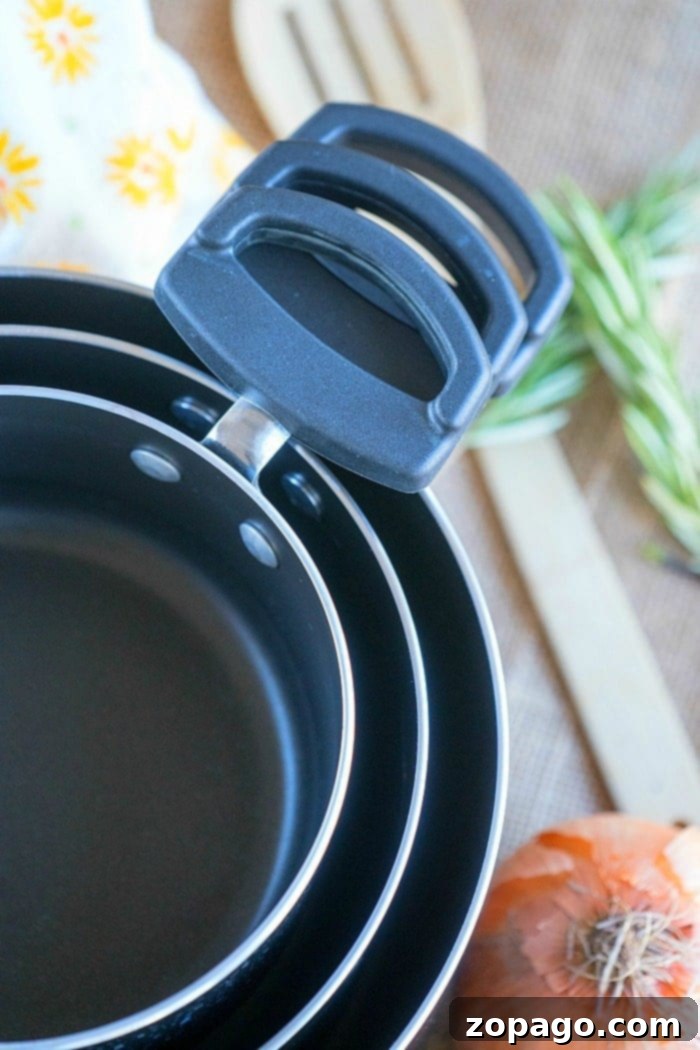 January Reset: Free Printable Declutter Checklist 3 neatly stacked nesting pots and pans for compact kitchen storage
