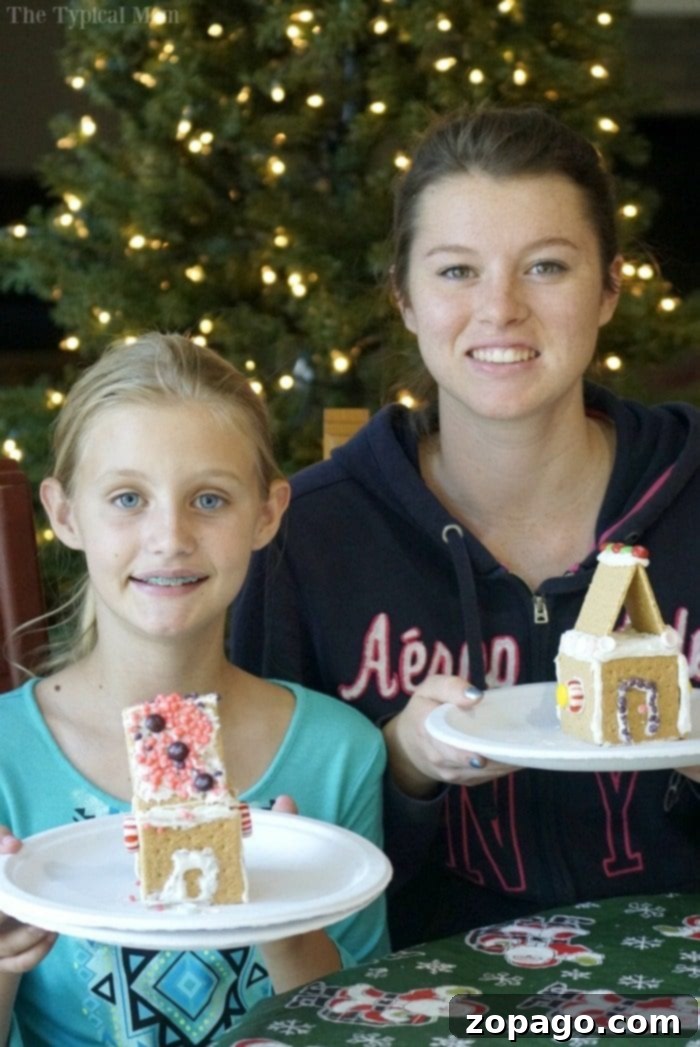 Happy family showing off their completed DIY Gingerbread House Kits.