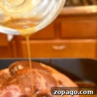 Drizzling a luscious baked ham glaze over a cooked ham in a cozy kitchen setting.