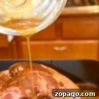 Drizzling a luscious baked ham glaze over a cooked ham in a cozy kitchen setting.
