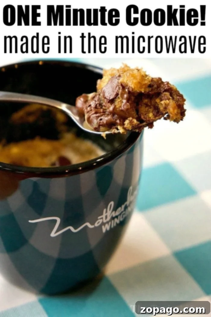 Chocolate Chip Mug Cookie 3 Cup with a spoonful of chocolate chip cookie in a mug, proudly displaying the text 'ONE Minute Cookie!' made effortlessly in the microwave.
