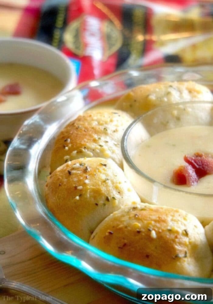 Gooey Cheesy Bacon Pull-Aparts 2 Golden-brown bacon cheese pull aparts with melted cheese oozing out, served with soup.