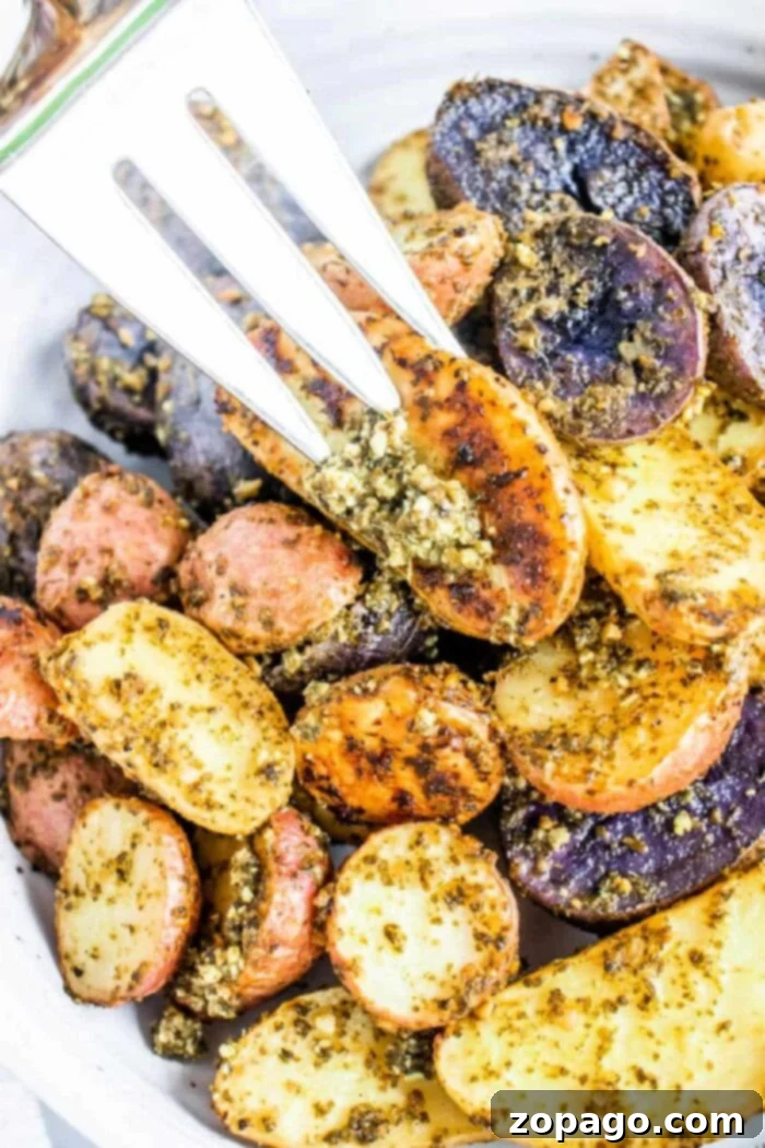 Flavorful Pesto Potatoes 7 A vibrant Pesto Potato Medley, featuring a mix of colorful roasted potatoes tossed in green pesto.