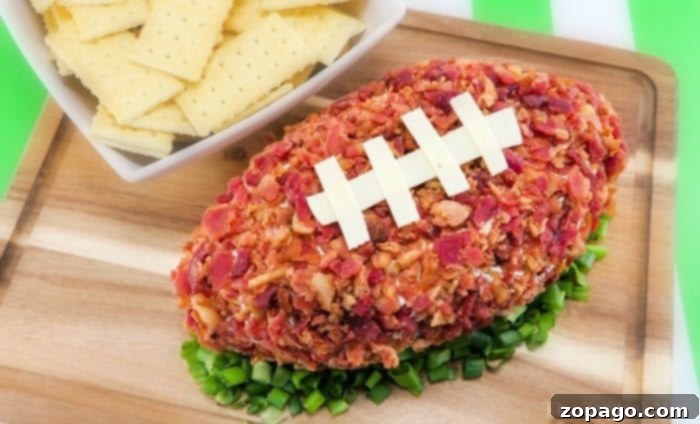 Football shaped cheese ball that's easy to make and yummy. The perfect football appetizer with bacon you'll ever make and everyone will rave over at your party. Perfect Super Bowl potluck appetizer that is cheap to make and really tasty with pretzels or crackers. #superbowlappetizer #football #cheeseball #cheese #appetizer #superbowl #bacon Easy and Yummy Football Shaped Cheese Ball Recipe, garnished with green onions