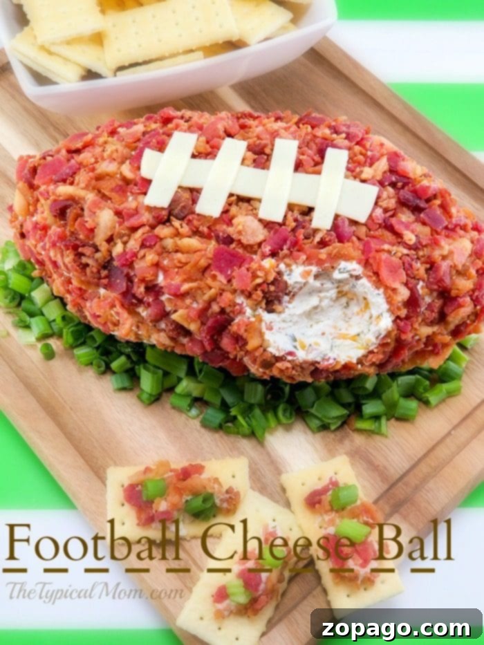 Football shaped cheese ball that's easy to make and yummy. The perfect football appetizer with bacon you'll ever make and everyone will rave over at your party. Perfect Super Bowl potluck appetizer that is cheap to make and really tasty with pretzels or crackers. #superbowlappetizer #football #cheeseball #cheese #appetizer #superbowl #bacon Festive Football Shaped Cheese Ball Display, ready for a party