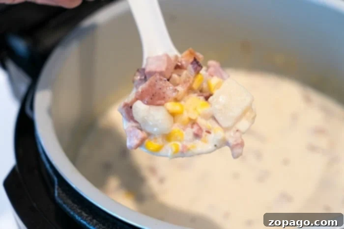 Creamy Instant Pot Potato Corn Chowder 6 A bowl of ham and corn chowder, showing the hearty texture with diced ham.