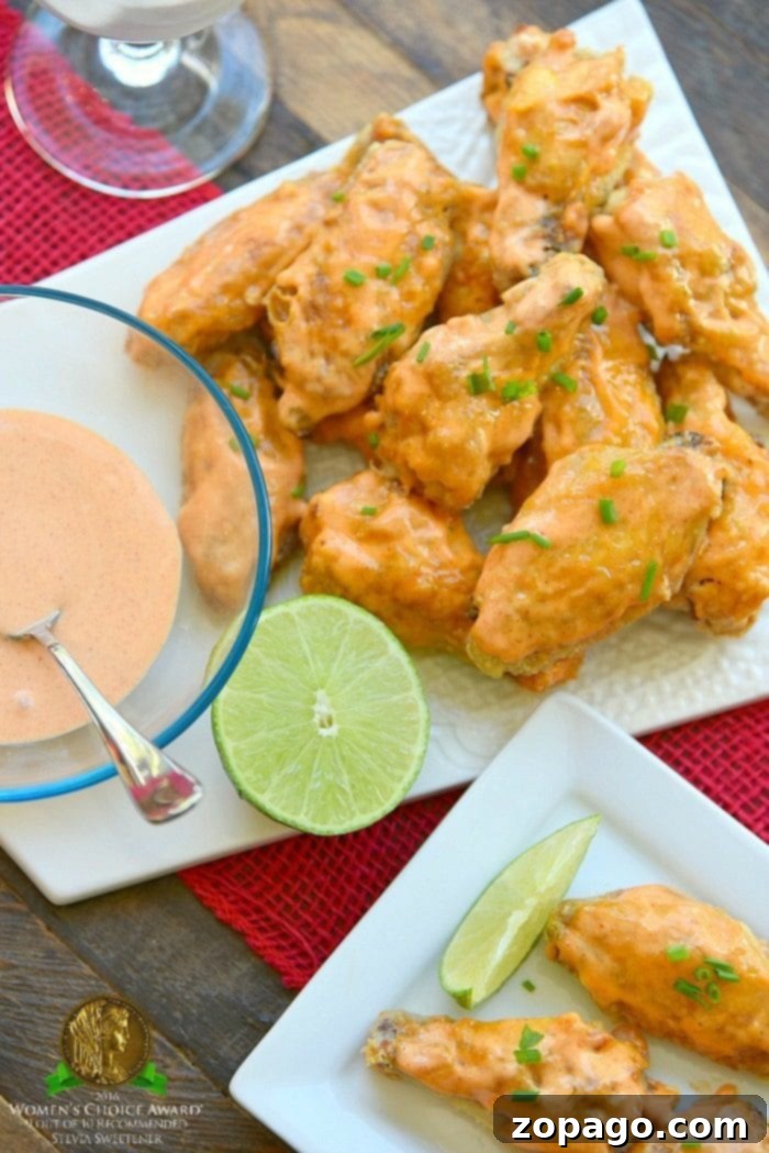 This is the best way to make a batch of sweet Sriracha baked chicken wings! The perfect appetizer or meal that's easy to make. These baked chicken wings are crispy and moist using this trick and the sauce is amazing with just the right sweet and heat you want. #chicken #wings #baked #sriracha #spicy #hot #sweet #crispy sweet sriracha baked chicken wings recipe