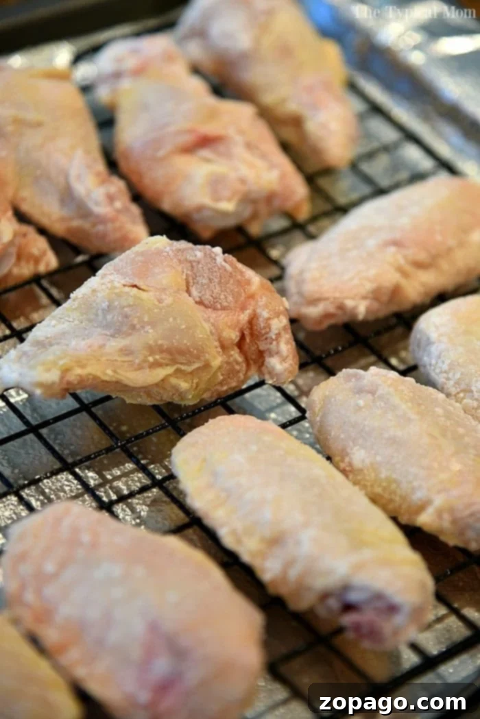 Achieve perfectly crispy chicken wings in the oven every time! A plate of golden, crispy oven baked chicken wings, showcasing the perfect texture achieved with this recipe.