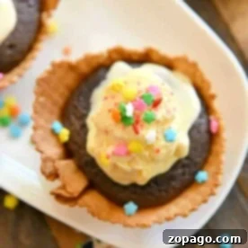 The Ultimate Waffle Bowl Cupcake Guide 4 Chocolate dessert in a waffle bowl topped with ice cream and colorful star-shaped sprinkles, a perfect sundae cupcake