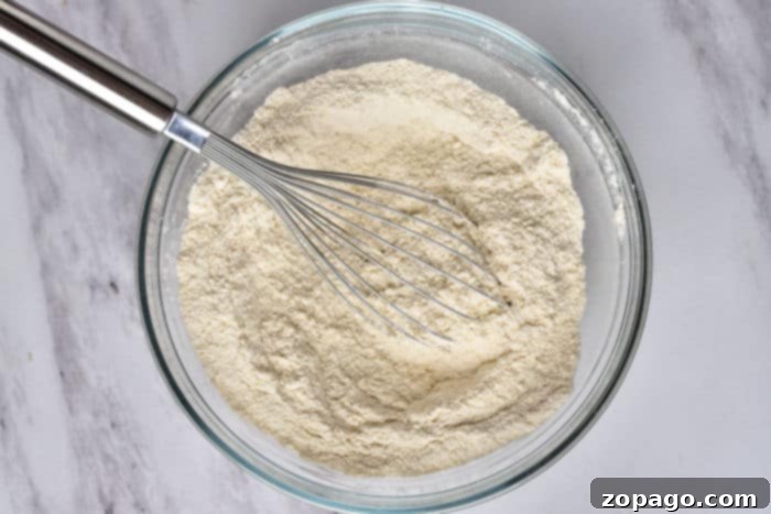 Effortless Tropical Poke Cake 2 Ingredients for homemade cake mix showing a bag of white cake mix and other dry ingredients.