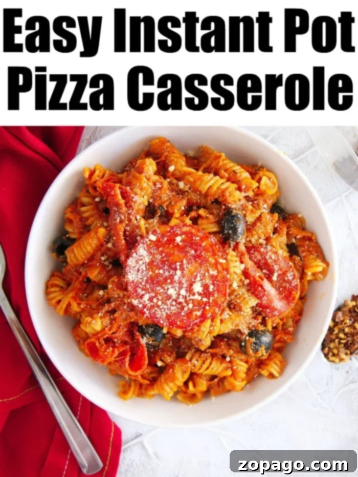Instant Pot pizza casserole is an amazing, easy family meal. Simply dump ingredients and your favorite pizza toppings into the pressure cooker for a delightful dinner. A generous serving of Instant Pot pizza casserole in a bowl, showing the rich, cheesy pasta ready for a family dinner.