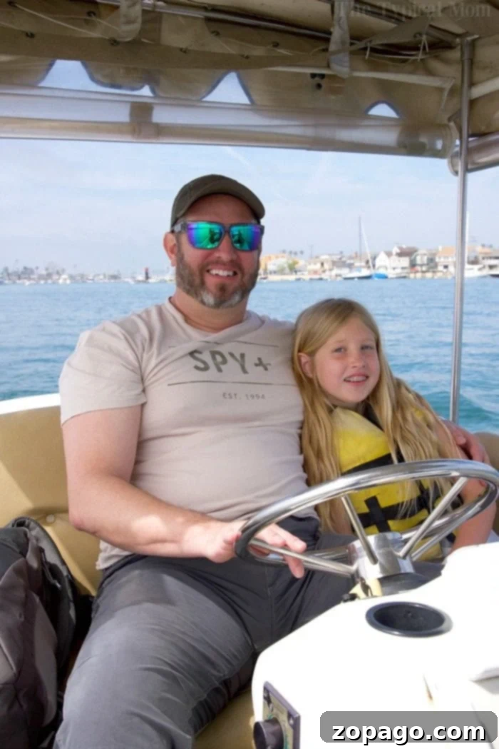 Balboa Fun Zone in Newport Beach is a fun place for families. There's the Balboa pier, beach, ride the ferry, and you can rent a boat too. Newport Beach boat rentals with family enjoying the view