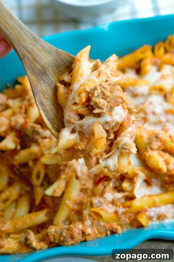 A perfect, super easy lasagna casserole recipe, loaded with cheese and meat, making it a kids' favorite. Close-up of a bubbling, cheesy lazy lasagna casserole fresh from the oven, showcasing melted mozzarella and ricotta with a rich sauce.