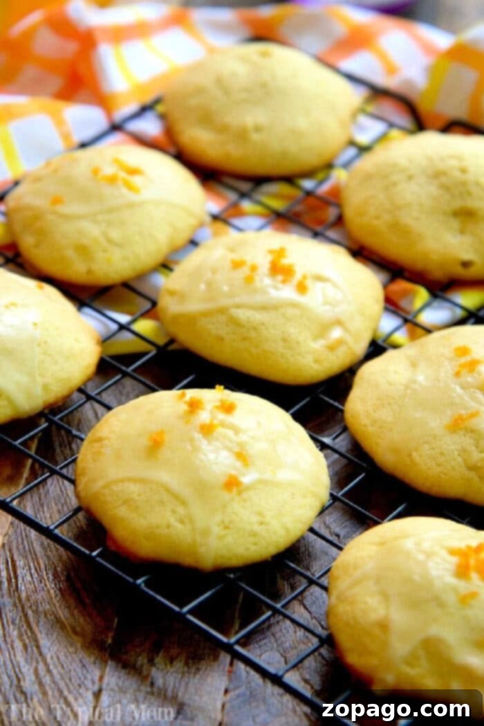 Easy Orange Creamsicle Cookies: Taste just like the popsicles you love! Using orange juice and a few other ingredients, they're a great Summer dessert. #creamsicle #cookies #orange Delicious homemade orange creamsicle cookies on a cooling rack