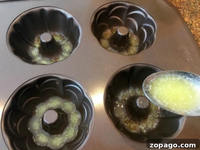Mini Bundt Bake Times 2 A perfectly golden mini bundt cake resting on a cooling rack, ready for glazing and toppings.