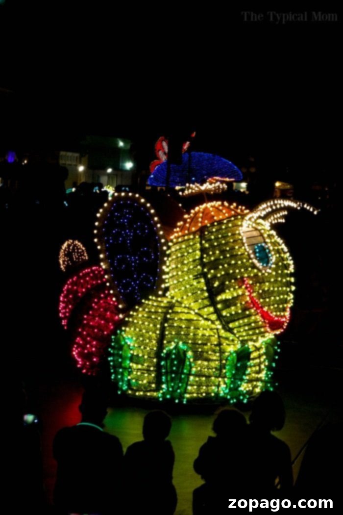 The Grand Spectacle of Disney's Illuminated Floats A beautifully illuminated float from the Disneyland Electrical Parade, showcasing intricate details and thousands of LED lights, passing by the crowd on Main Street.
