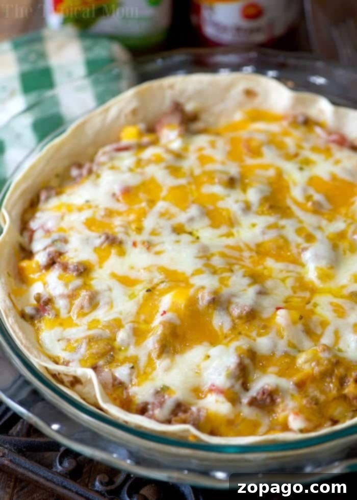 These crispy individual air fryer Mexican pizzas are a great alternative to the classic casserole, perfect for personalized servings. Individual Taco Bell Mexican Pizza made in an air fryer, with melted cheese and fresh toppings.