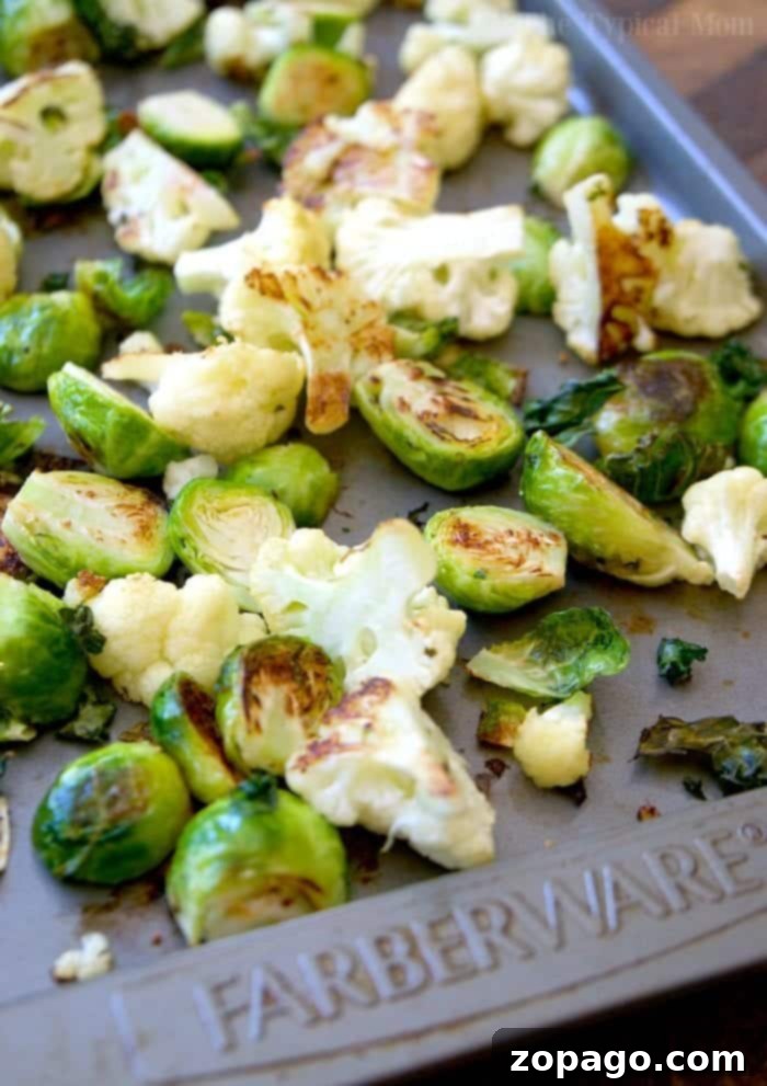 Creamy salsa verde brussel sprouts and cauliflower is a great side dish or vegetarian meal that is packed with punches of flavor! #brusselsprouts #califlower #baked #vegetable #vegetarian #crispy #keto #salsaverde Baked Brussel Sprouts and Cauliflower with creamy salsa verde