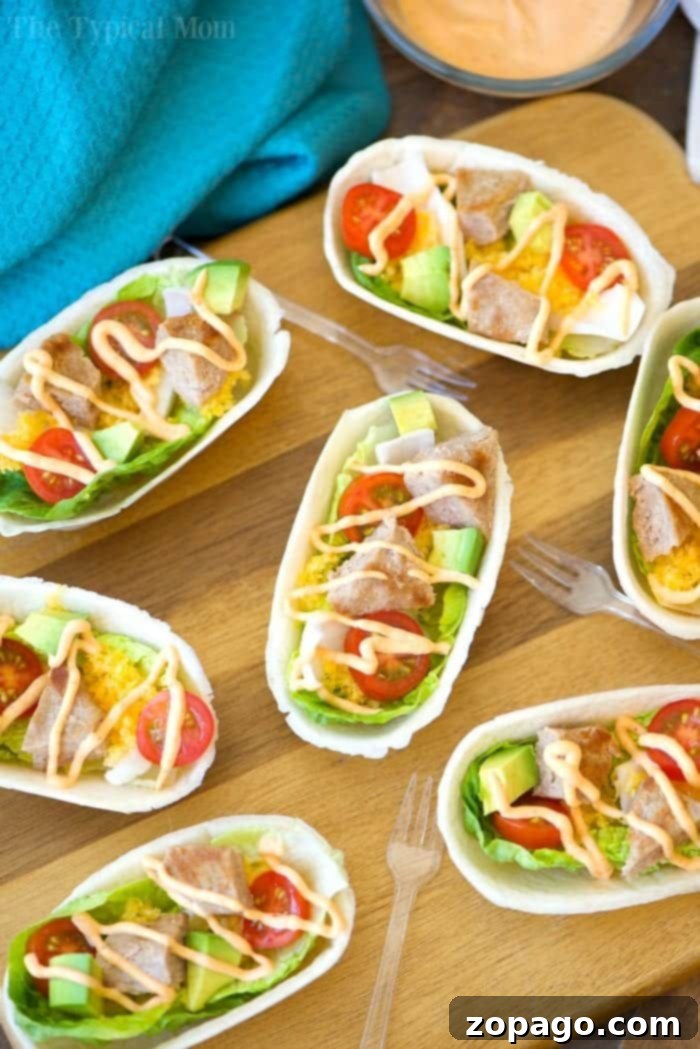 These mini turkey burger boats are the best appetizers! Packed with protein and fresh produce they are the perfect bite size for everyone, and healthy too. #appetizers #burger #groundbeef #boats #hamburger A tray of freshly prepared turkey burger boats ready for serving.
