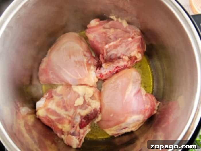 Instant Pot Fiery Teriyaki Chicken Thighs 3 Instant Pot chicken thighs simmering in a thick teriyaki sauce.
