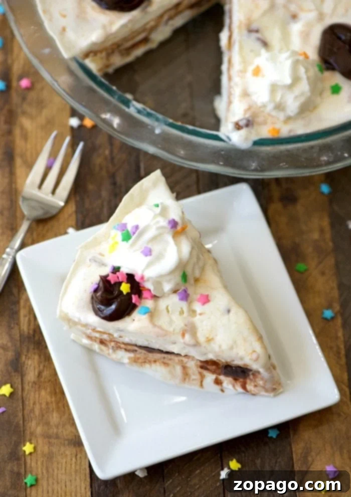 Decadent Sundae Pie 6 A vibrant, easy ice cream sundae pie slice on a plate, showcasing its delightful layers, whipped cream, and sprinkles.