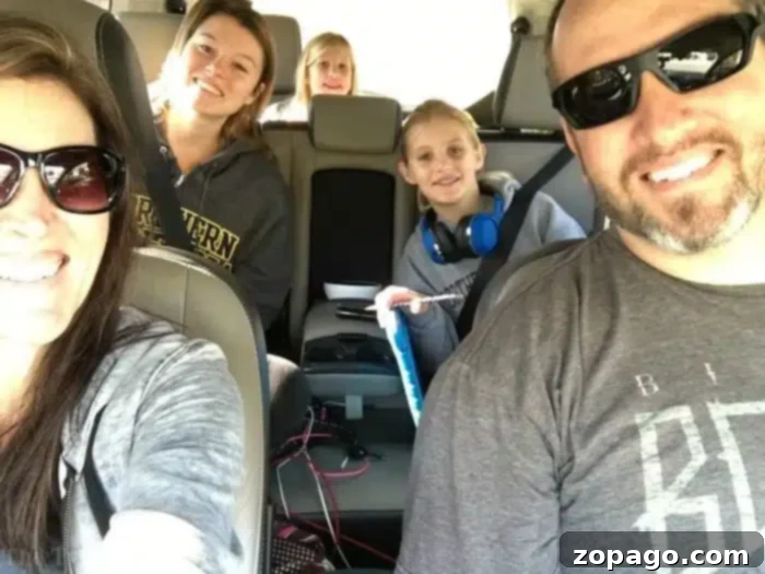 Engaging Car Games for Kids on Family Road Trips Happy family playing car games on a road trip, with children wearing headphones and smiling.